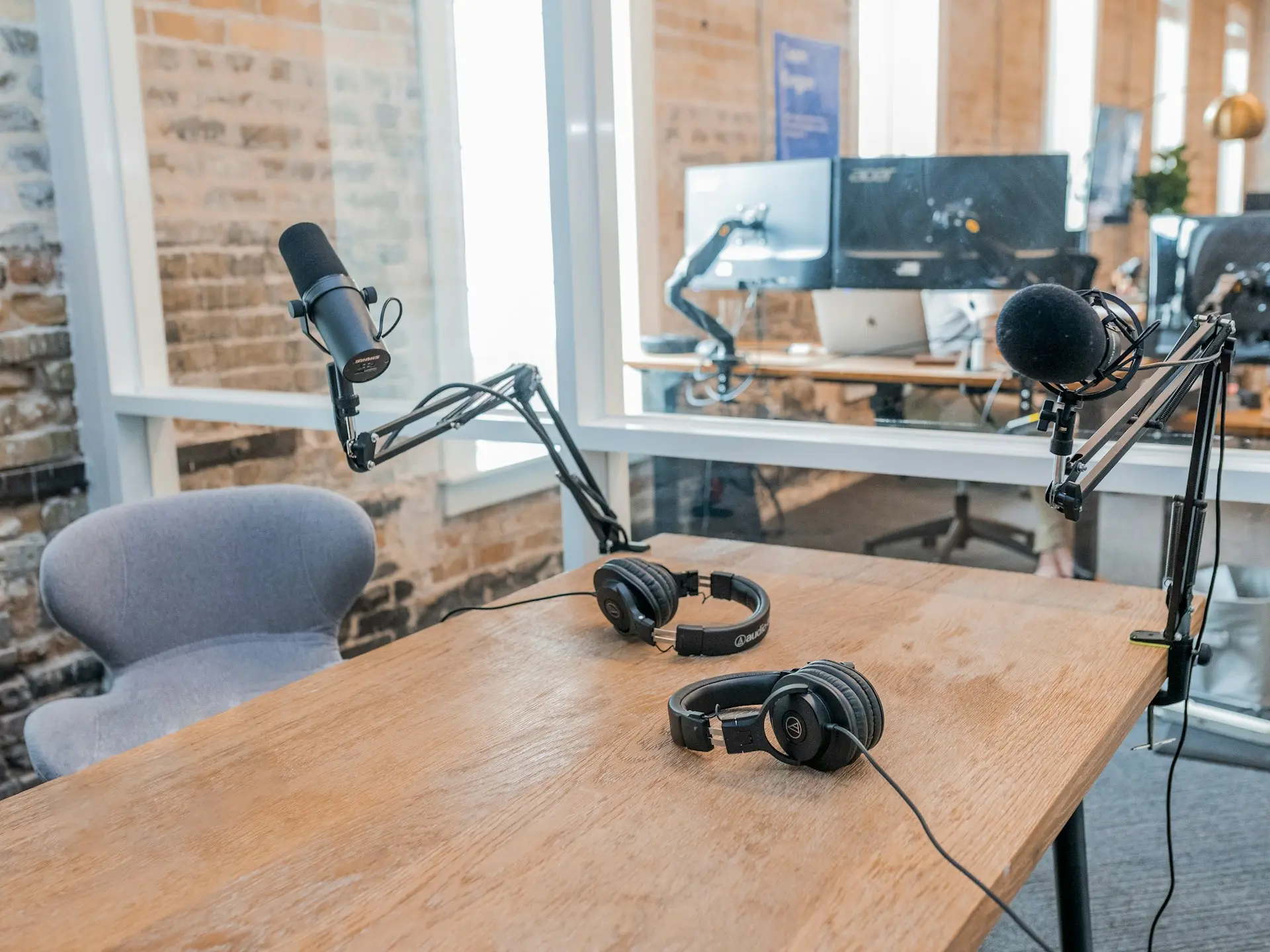 two black headphones on brown wooden table